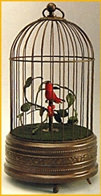 Oiseaux chanteurs m&eacute;caniques Oiseau chanteur m&eacute;canique : 1 oiseau chanteur automate dans cage ancienne