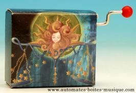 Boîtes à musique à manivelle en carton illustré Boîte à musique à manivelle : boîte à musique en carton avec le signe de la balance