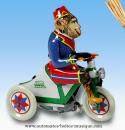 Jouet mécanique en métal, tôle et fer blanc : jouet mécanique singe sur un tricycle